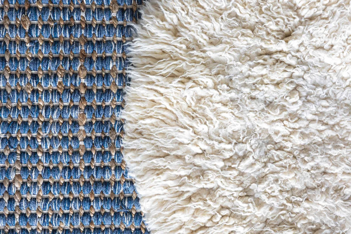Close detail of an ivory and blue carpet weave